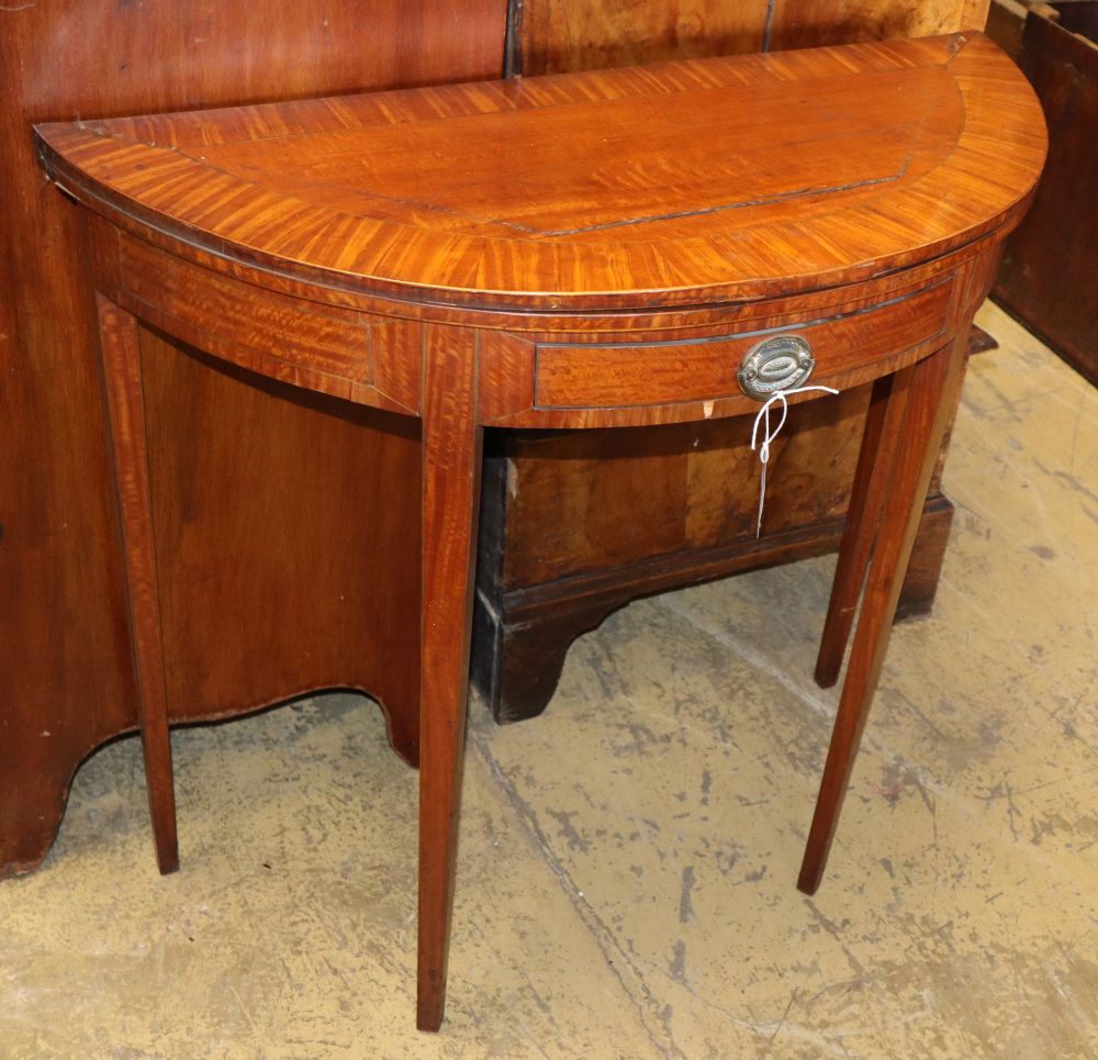 A George III satinwood oval folding card table, W.86cm, D.38cm, H.79cm